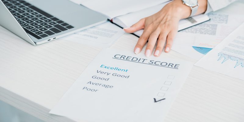 cropped view of woman showing credit score at office