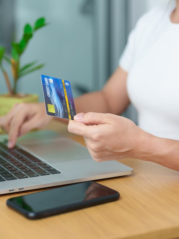 woman hand holding credit card and using laptop